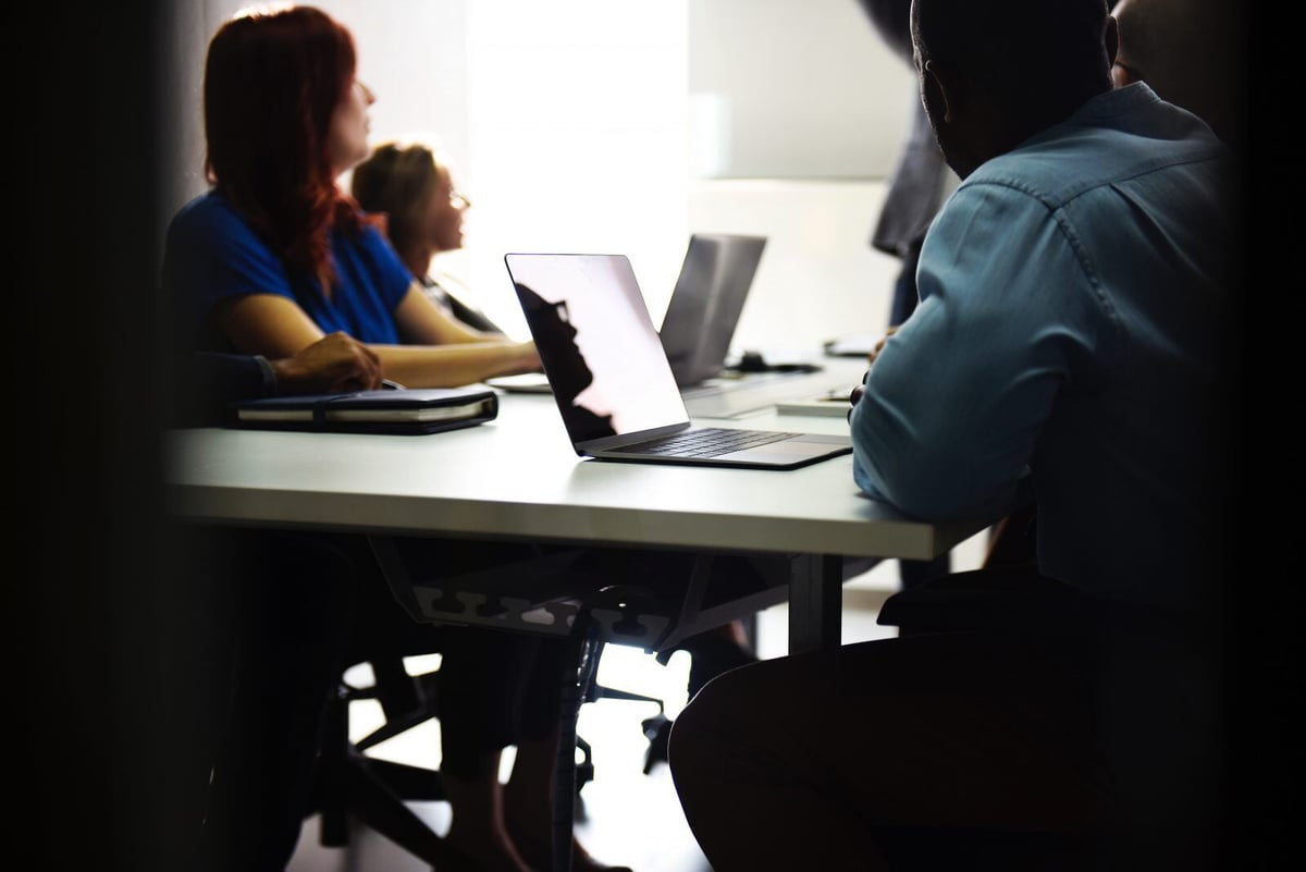 People at conference table in office environment